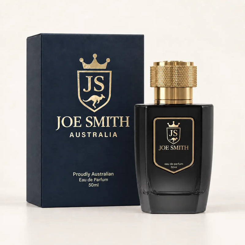 Joe Smith 50 ml black perfume bottle with gold cap beside its navy presentation box