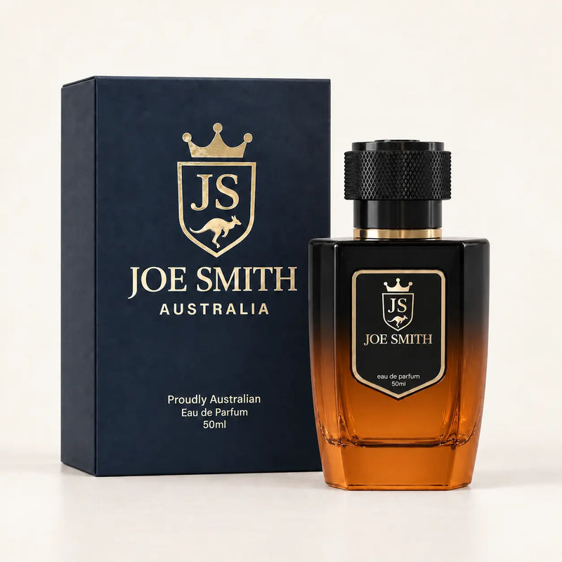 Joe Smith 50 ml black-to-orange perfume bottle with black cap beside its navy presentation box