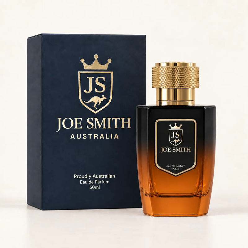 Joe Smith 50 ml black-to-orange perfume bottle with gold cap beside its navy presentation box