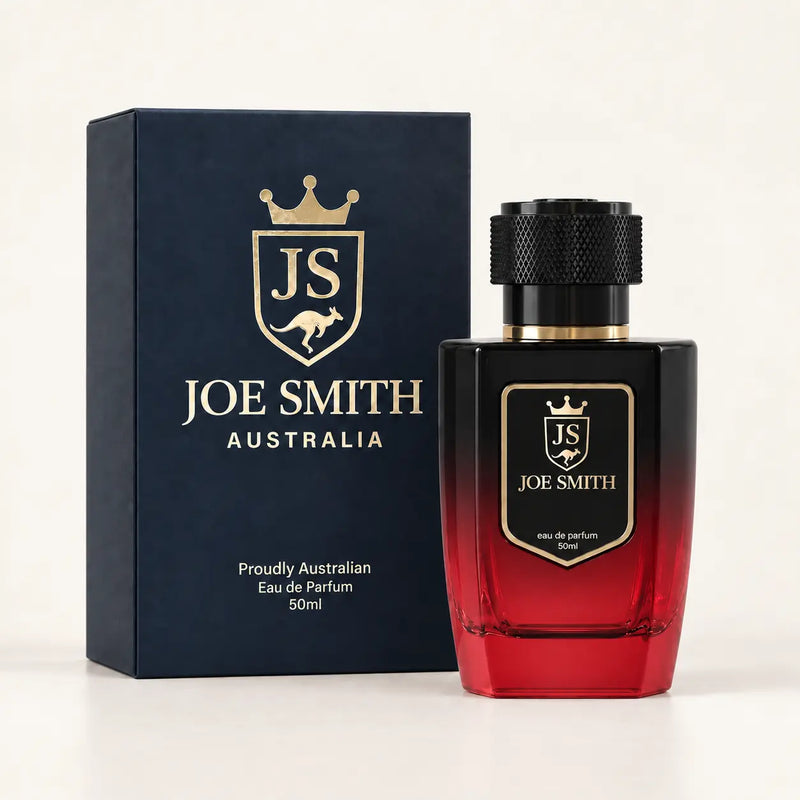 Joe Smith 50 ml black-to-red perfume bottle with black cap beside its navy presentation box