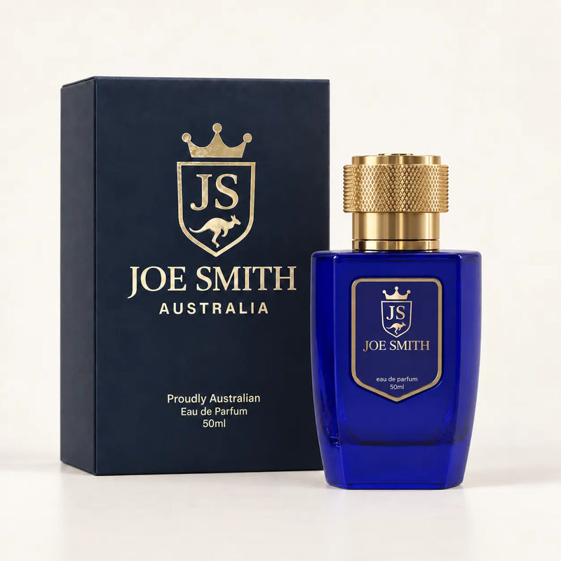 Joe Smith 50 ml royal blue perfume bottle with gold cap beside its navy presentation box