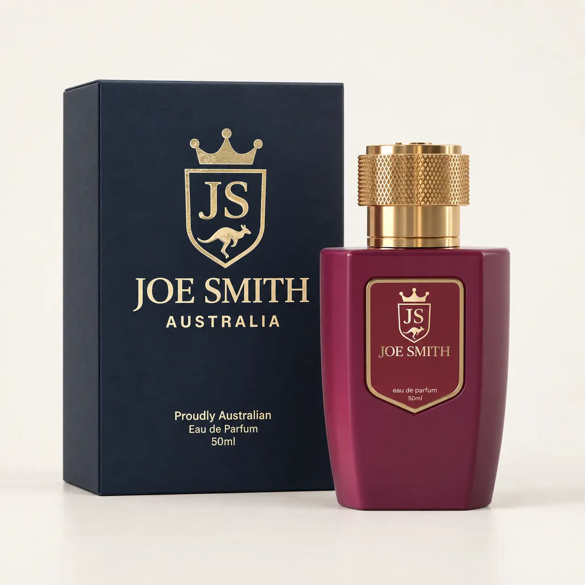 Joe Smith 50 ml burgundy perfume bottle with gold cap beside its navy presentation box