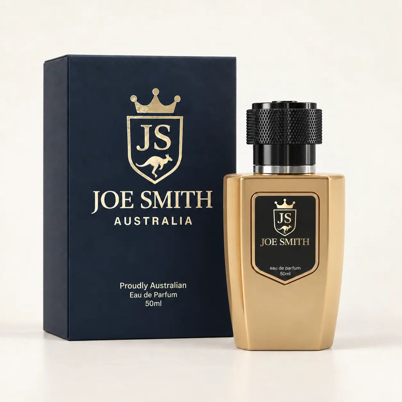 Joe Smith 50 ml gold perfume bottle with black cap beside its navy presentation box
