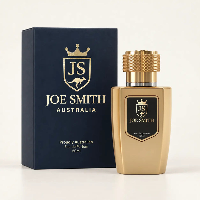 Joe Smith 50 ml gold perfume bottle with gold cap beside its navy presentation box