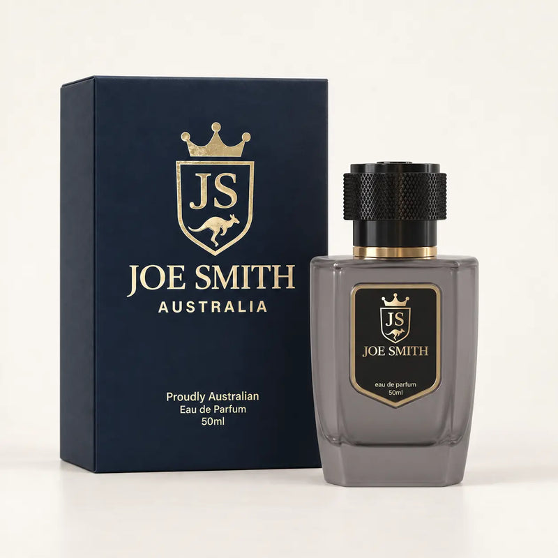 Joe Smith 50 ml smoky grey perfume bottle with black cap beside its navy presentation box