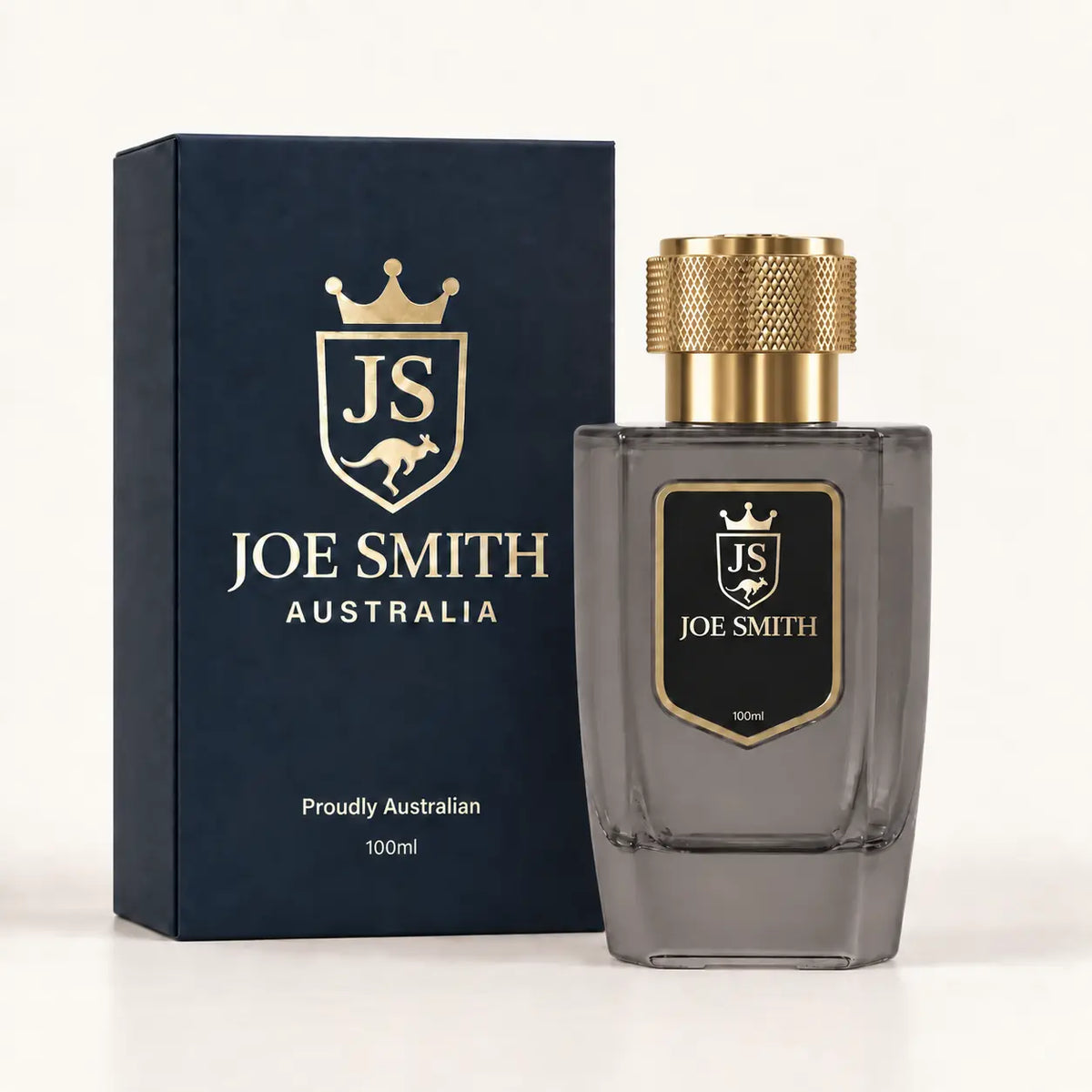 Joe Smith 100 ml smoky grey perfume bottle with gold cap beside its navy presentation box