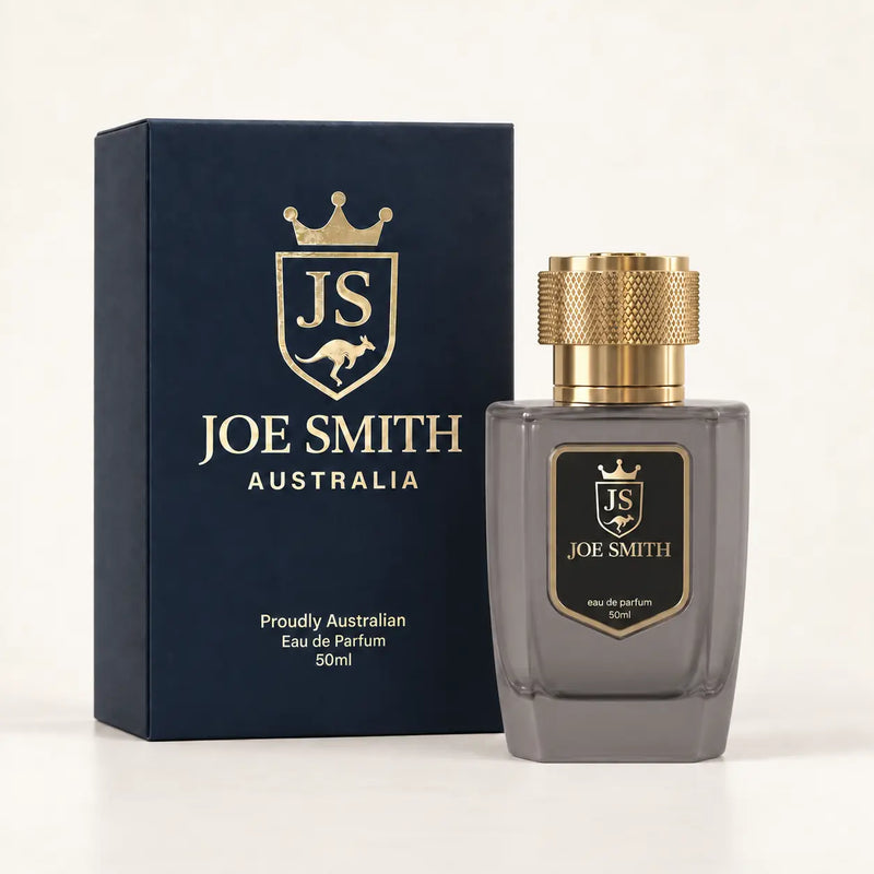 Joe Smith 50 ml smoky grey perfume bottle with gold cap beside its navy presentation box