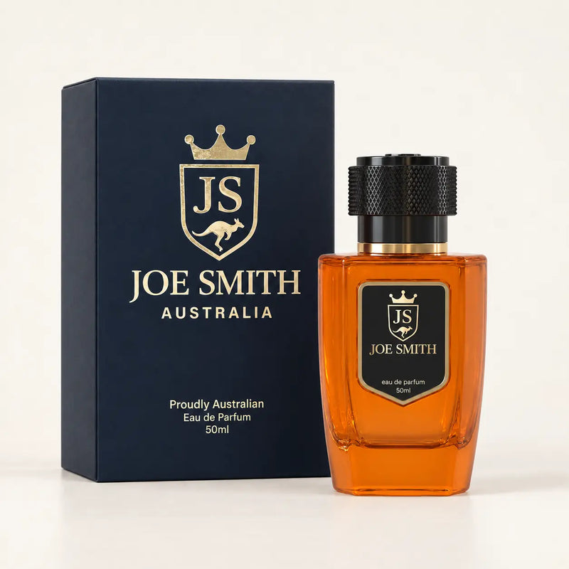 Joe Smith 50 ml orange perfume bottle with black cap beside its navy presentation box