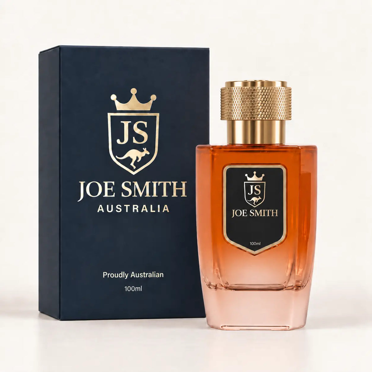 Joe Smith 100 ml orange perfume bottle with gold cap beside its navy presentation box