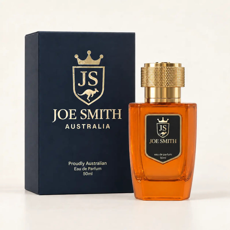 Joe Smith 50 ml orange perfume bottle with gold cap beside its navy presentation box