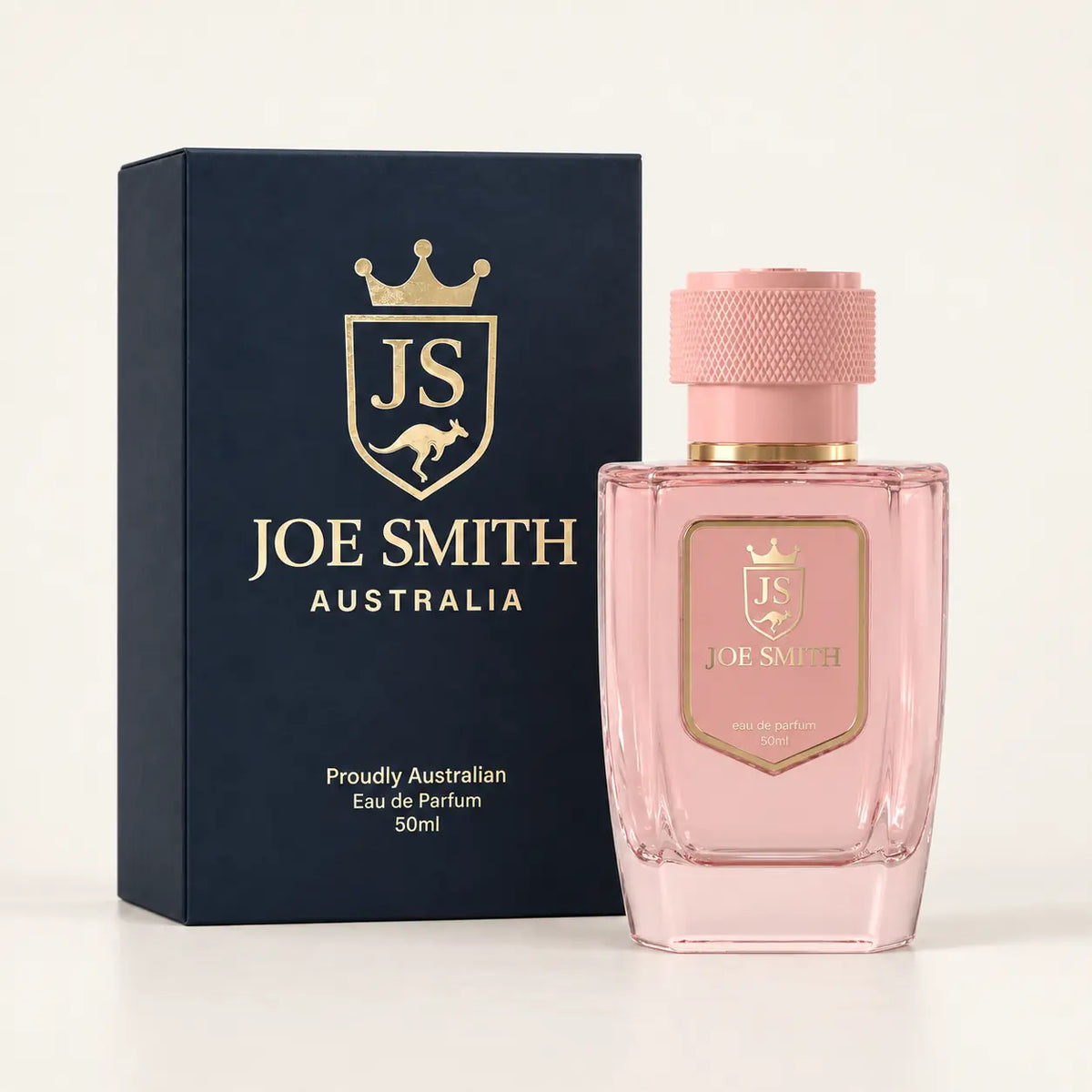 Joe Smith 50 ml pink perfume bottle with pink cap beside its navy presentation box