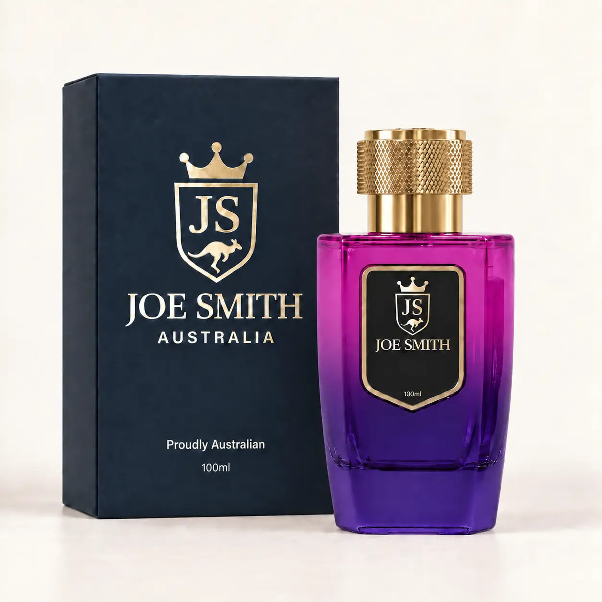 Joe Smith 100 ml magenta-to-purple perfume bottle with gold cap beside its navy presentation box