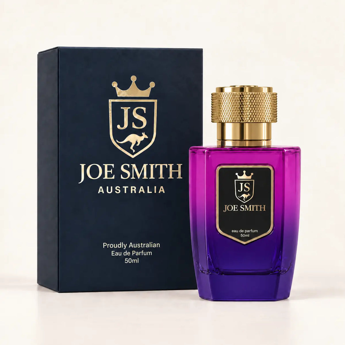 Joe Smith 50 ml magenta-to-purple perfume bottle with gold cap beside its navy presentation box